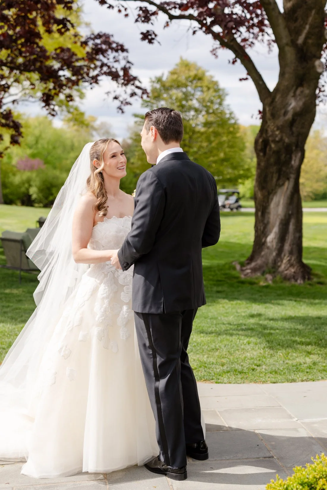 Bride and groom laugh together during their Quaker Ridge Golf Club wedding