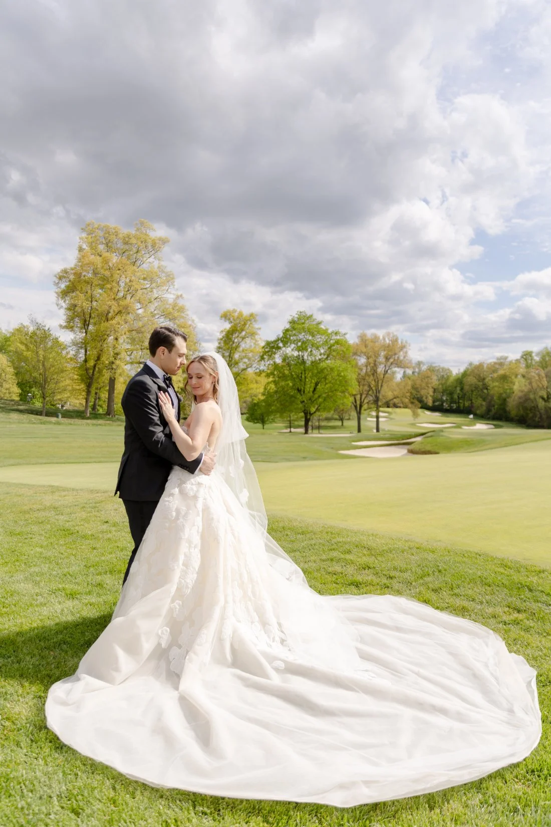 Bride and groom pose on the golf course during their Quaker Ridge Golf Club wedding