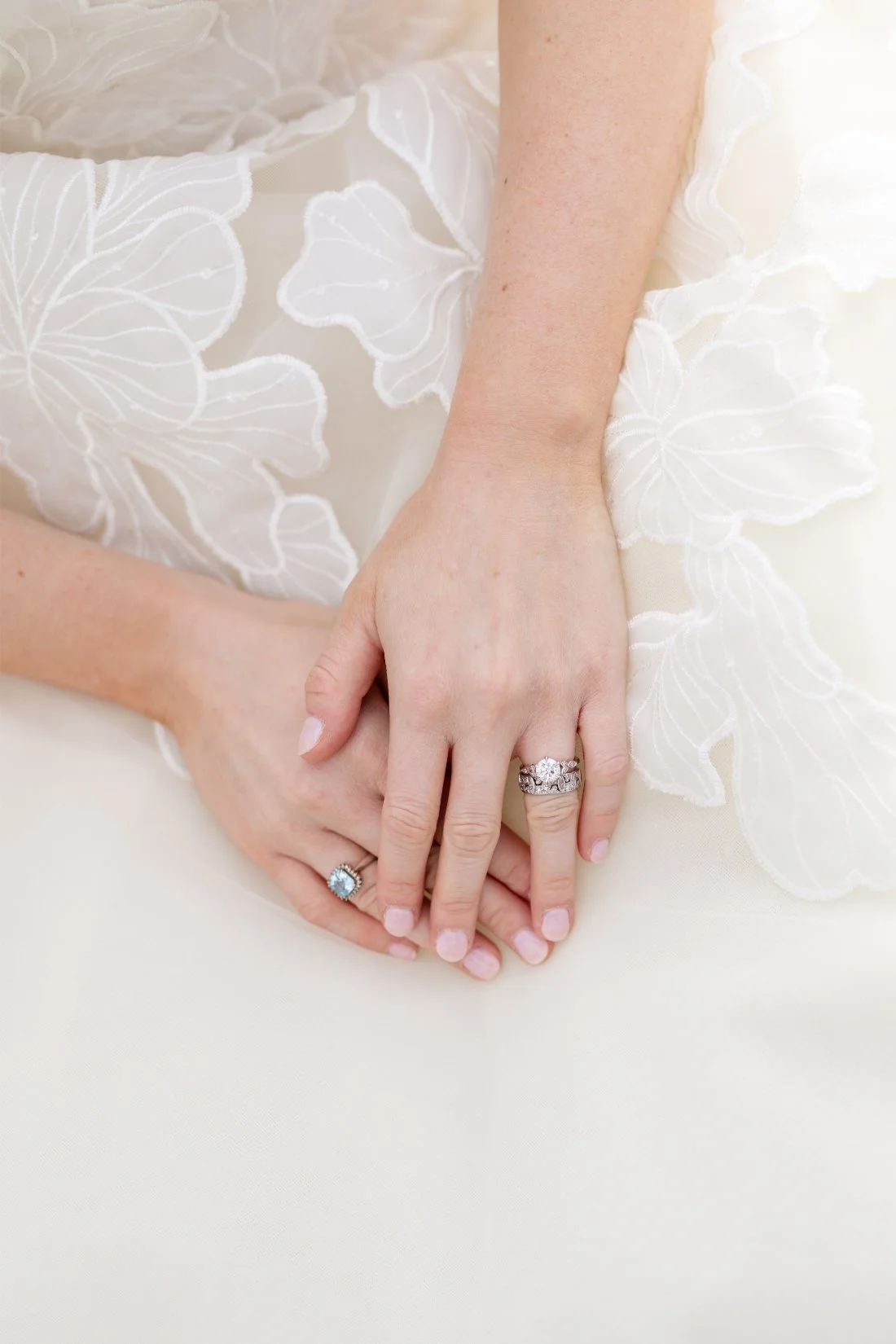 Close-up of wedding rings and floral gown details at a Quaker Ridge Golf Club wedding
