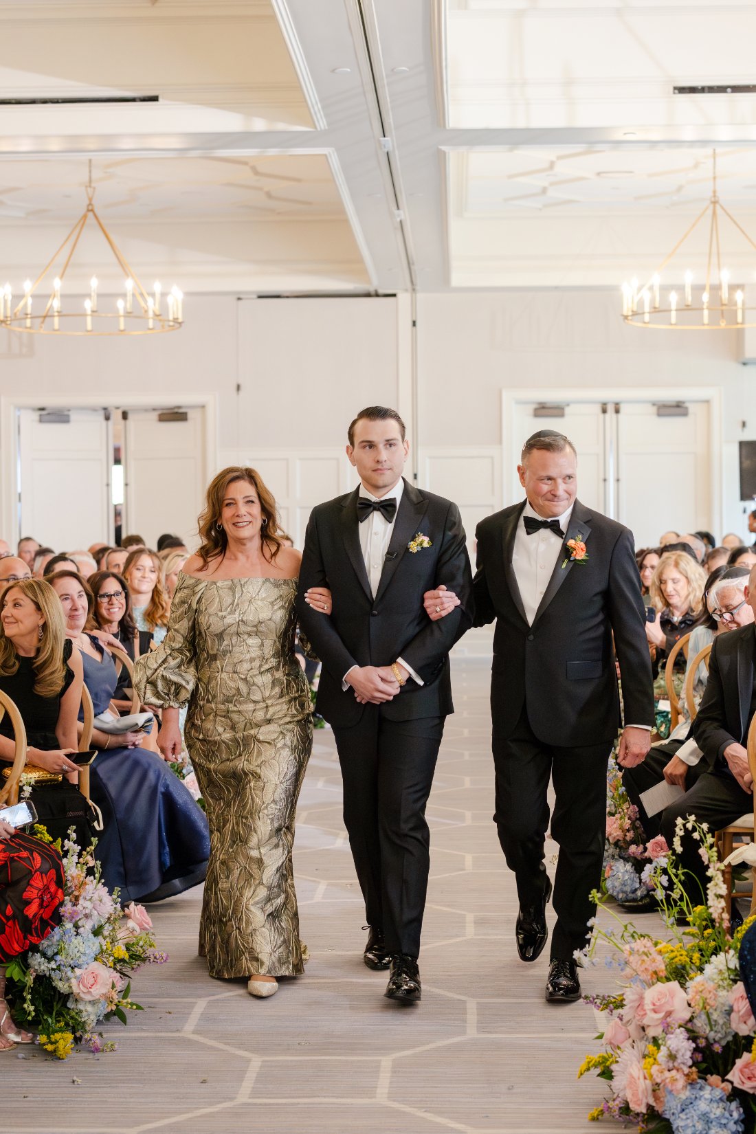 Groom making his entrance at the start of his Quaker Ridge Golf Club wedding ceremony.