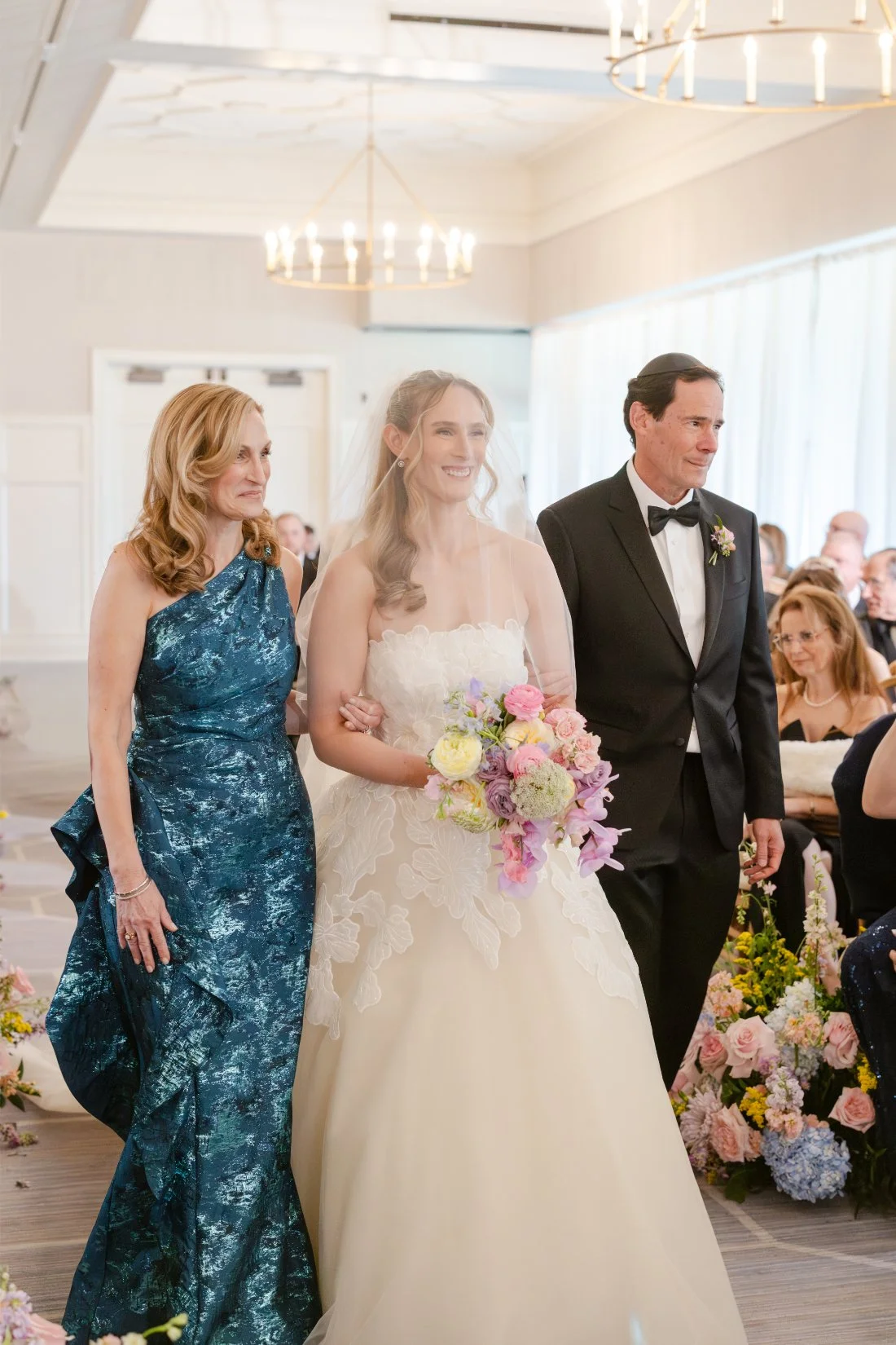Bride walking down the aisle with her parents at her Quaker Ridge Golf Club wedding.