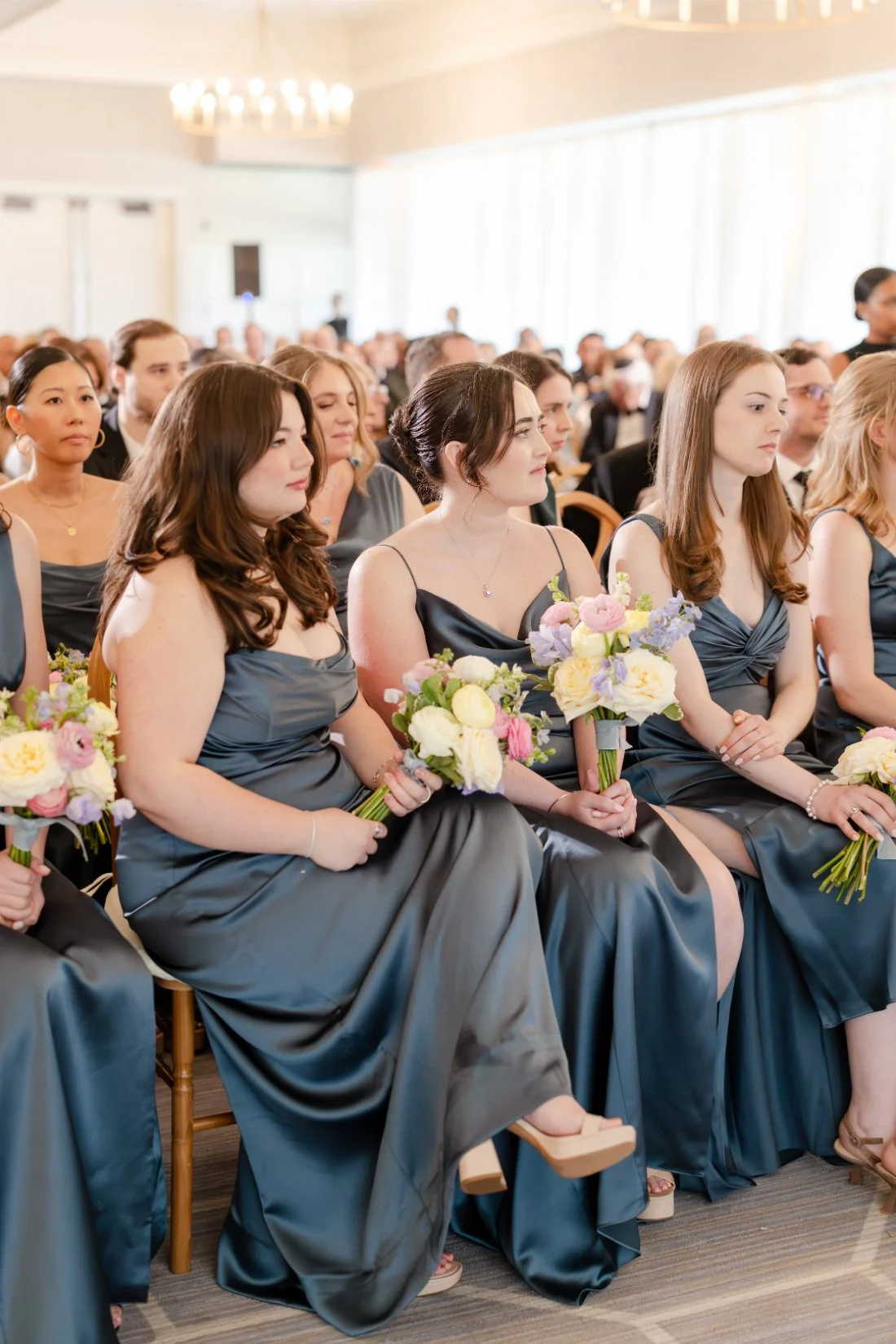 Bridesmaids seated together during the Quaker Ridge Golf Club wedding ceremony.