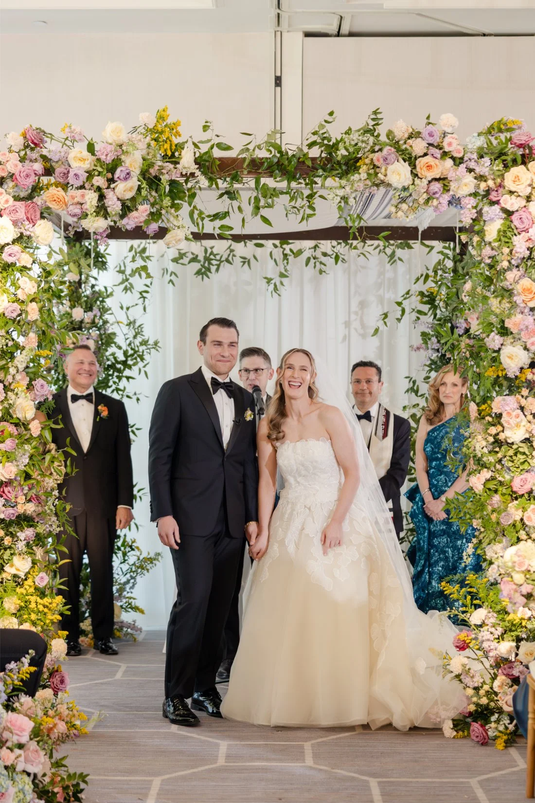 Bride and groom looking out at their guests during their Quaker Ridge Golf Club wedding.