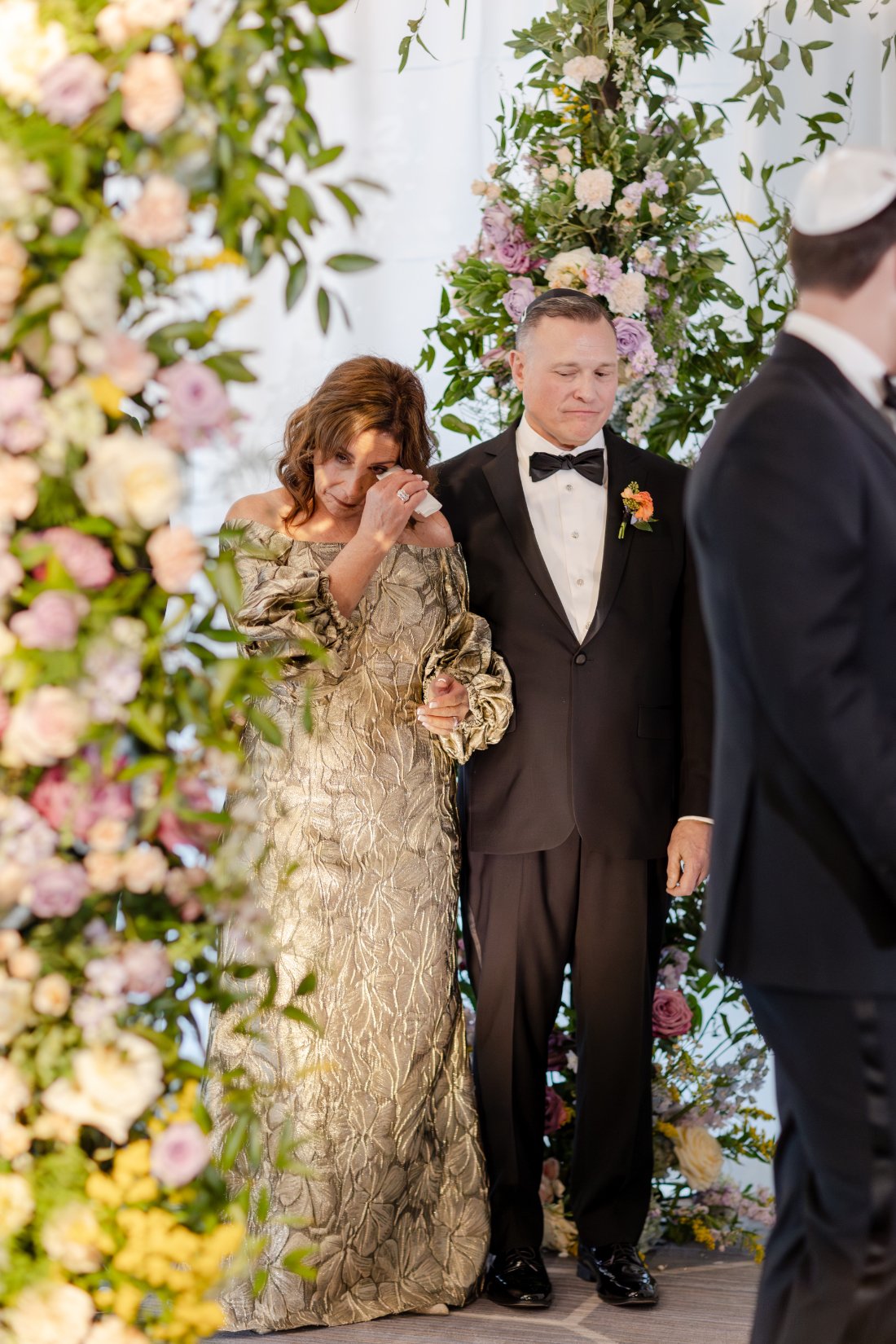 Emotional wedding guest crying during the ceremony.
