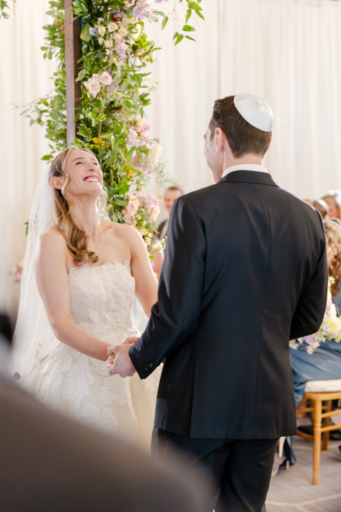 Bride laughing during a joyful moment at her Quaker Ridge Golf Club wedding ceremony.