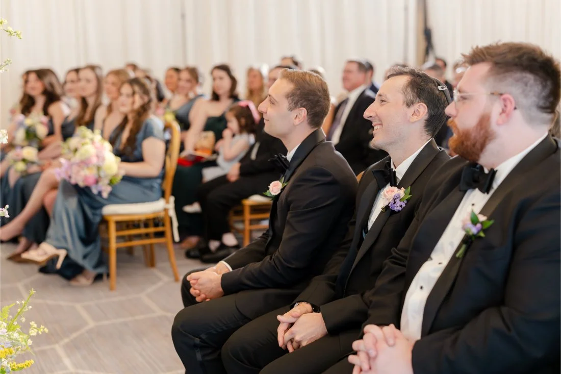 Wedding guests watching the couple during the ceremony.