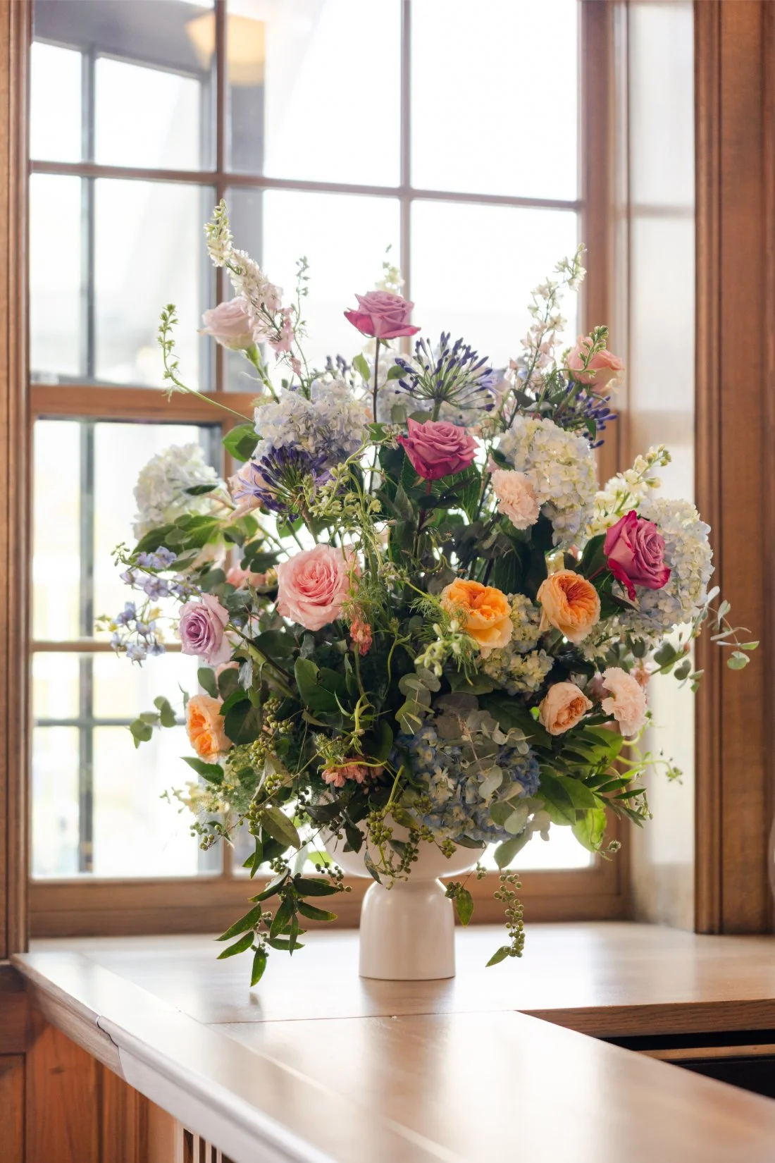 Colorful wedding florals arranged for cocktail hour.