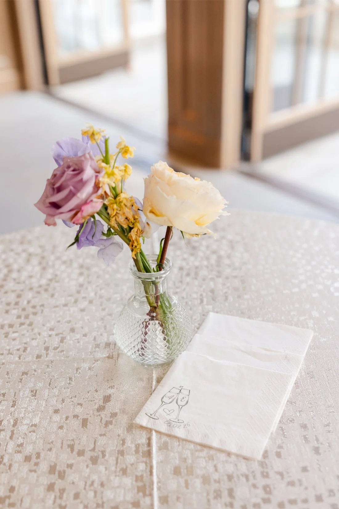 Colorful floral arrangement decorating a table at a Quaker Ridge Golf Club wedding.