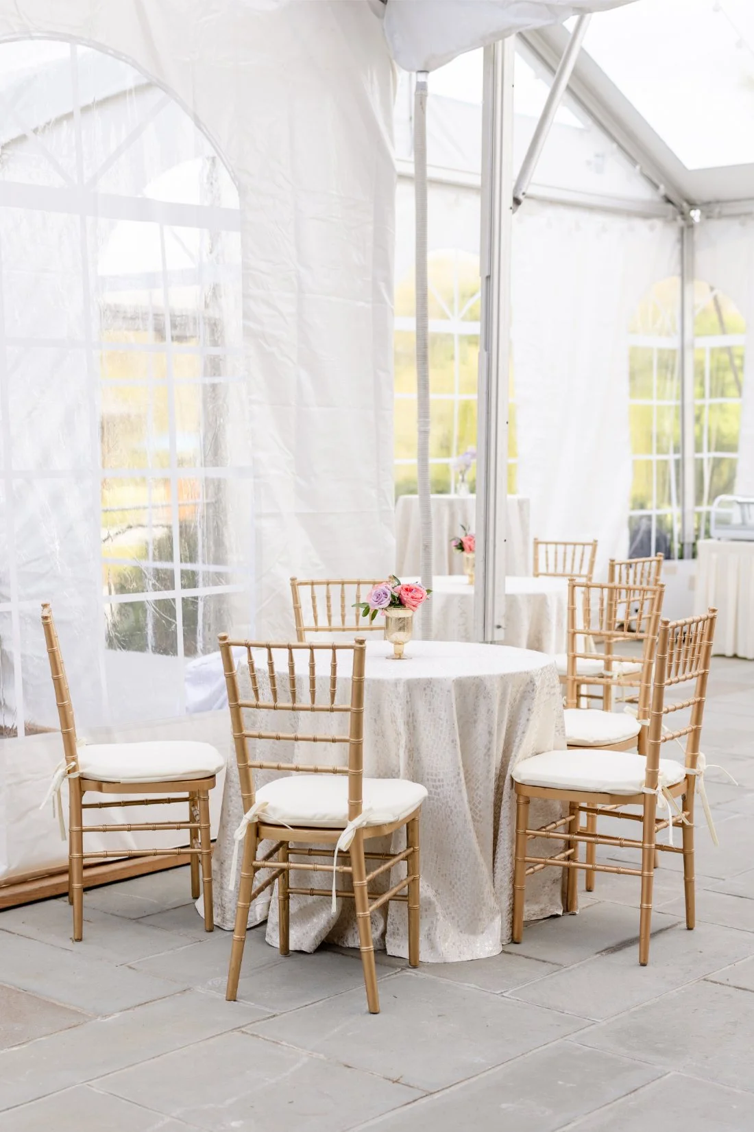 Elegant cocktail hour table set with florals and guest details.