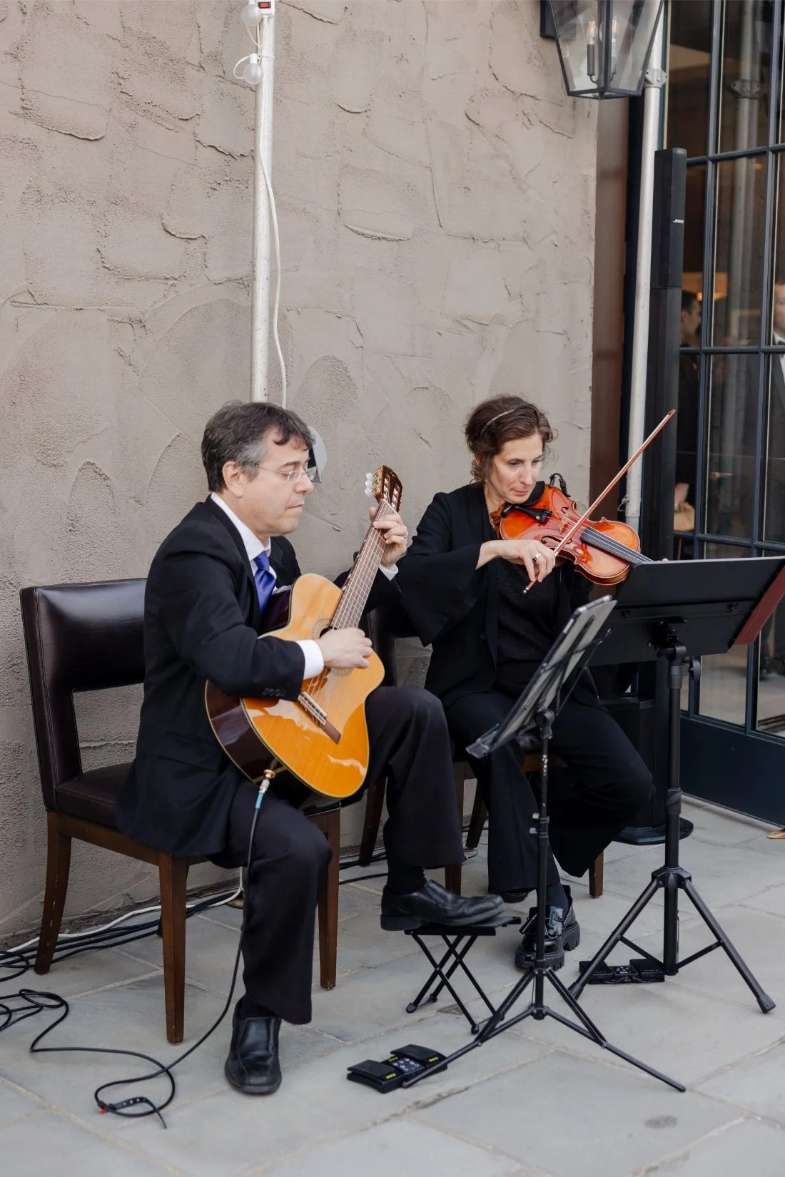 Live musicians performing during a Quaker Ridge Golf Club wedding cocktail hour.