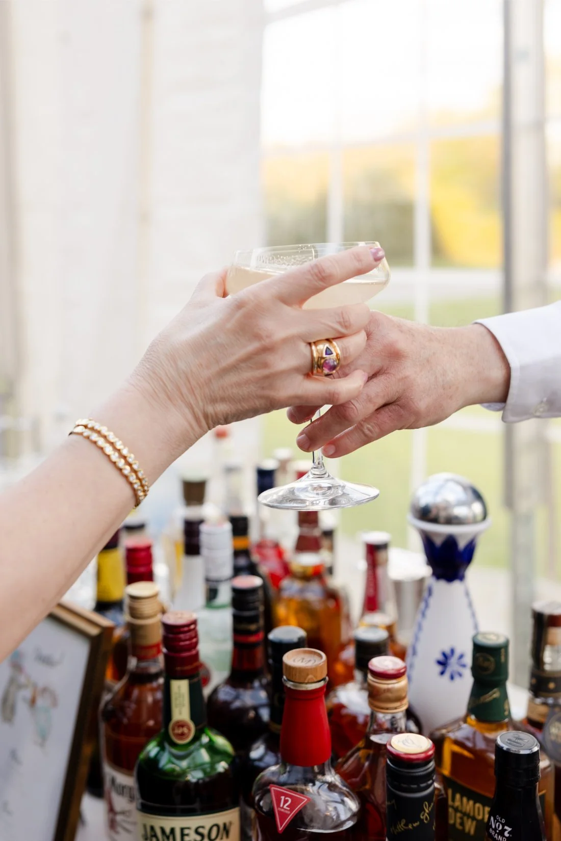 Cocktail being handed to a guest during a Quaker Ridge Golf Club wedding.