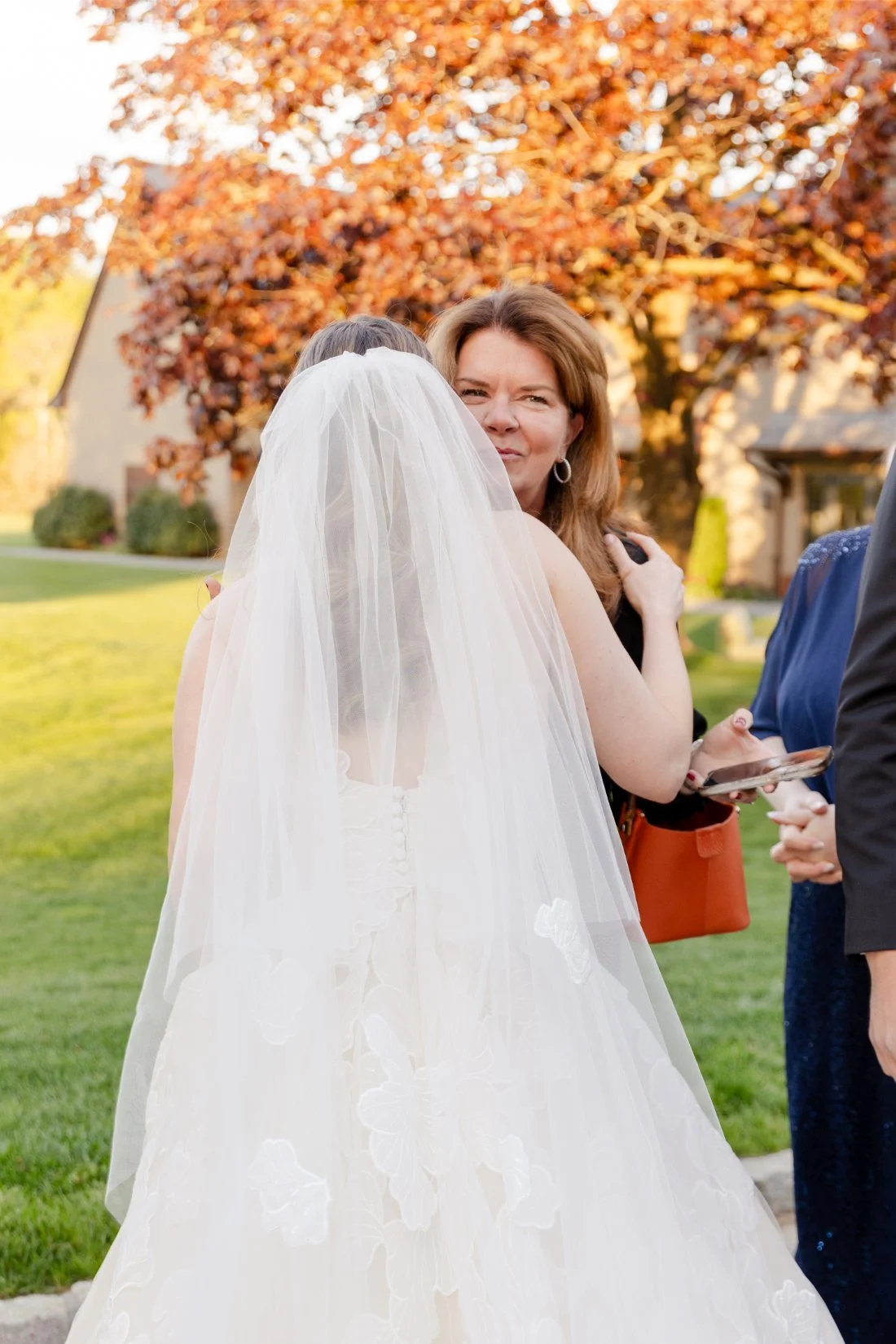 Bride hugging a guest during cocktail hour.