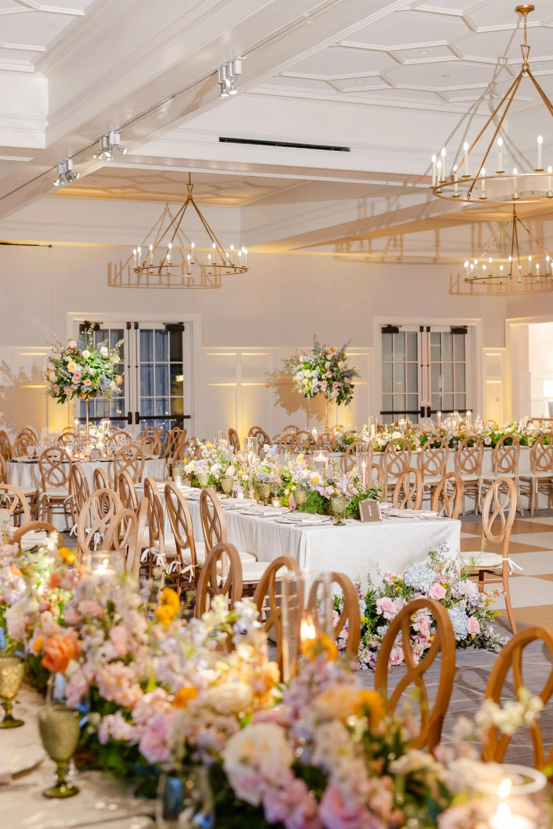 Reception space decorated with lush colorful florals and elegant table settings.