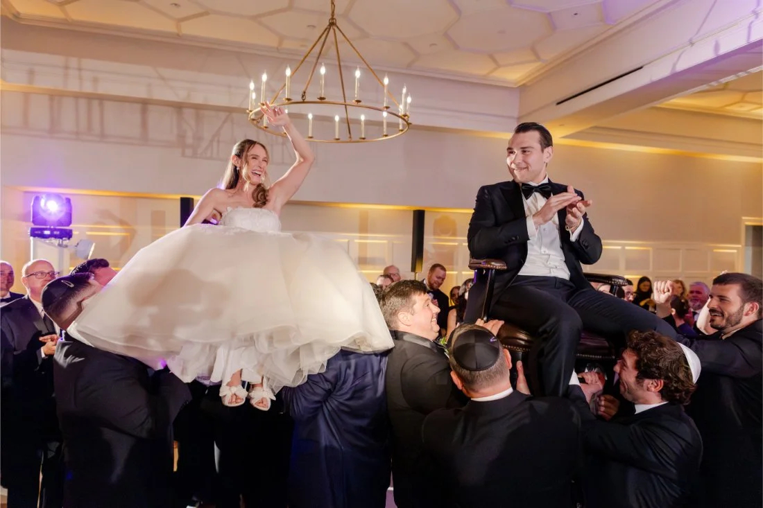 Bride and groom lifted into the air during the traditional Jewish Hora dance.