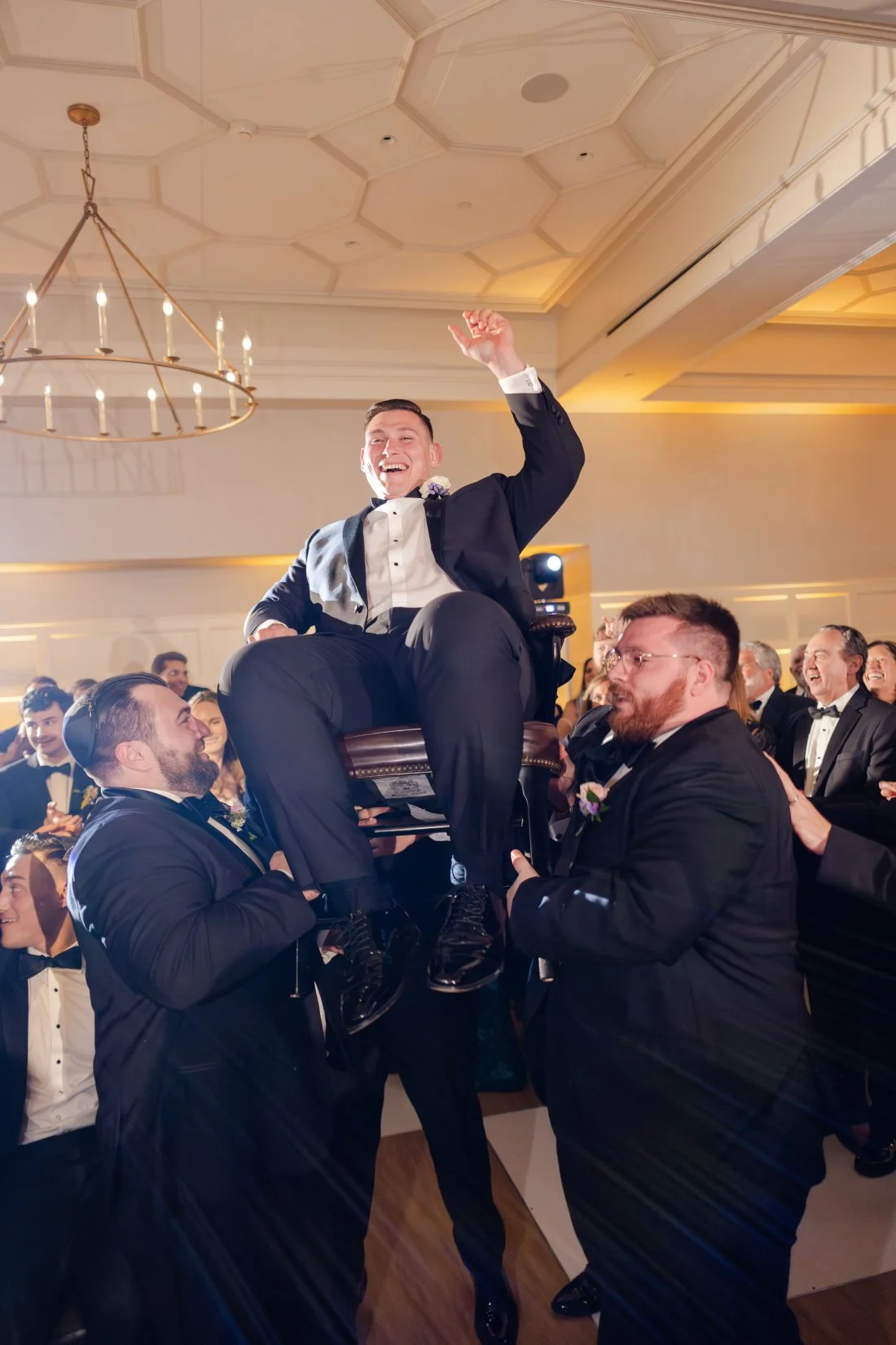 Guests celebrating the newlyweds during the Hora at their Quaker Ridge Golf Club wedding reception.