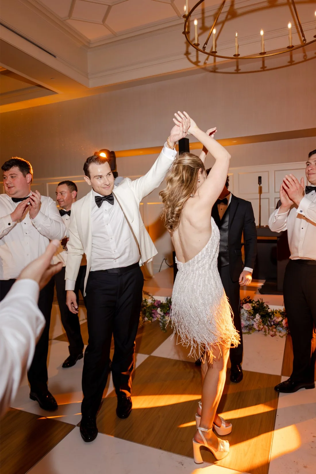 Bride and groom dancing together during the evening celebration.