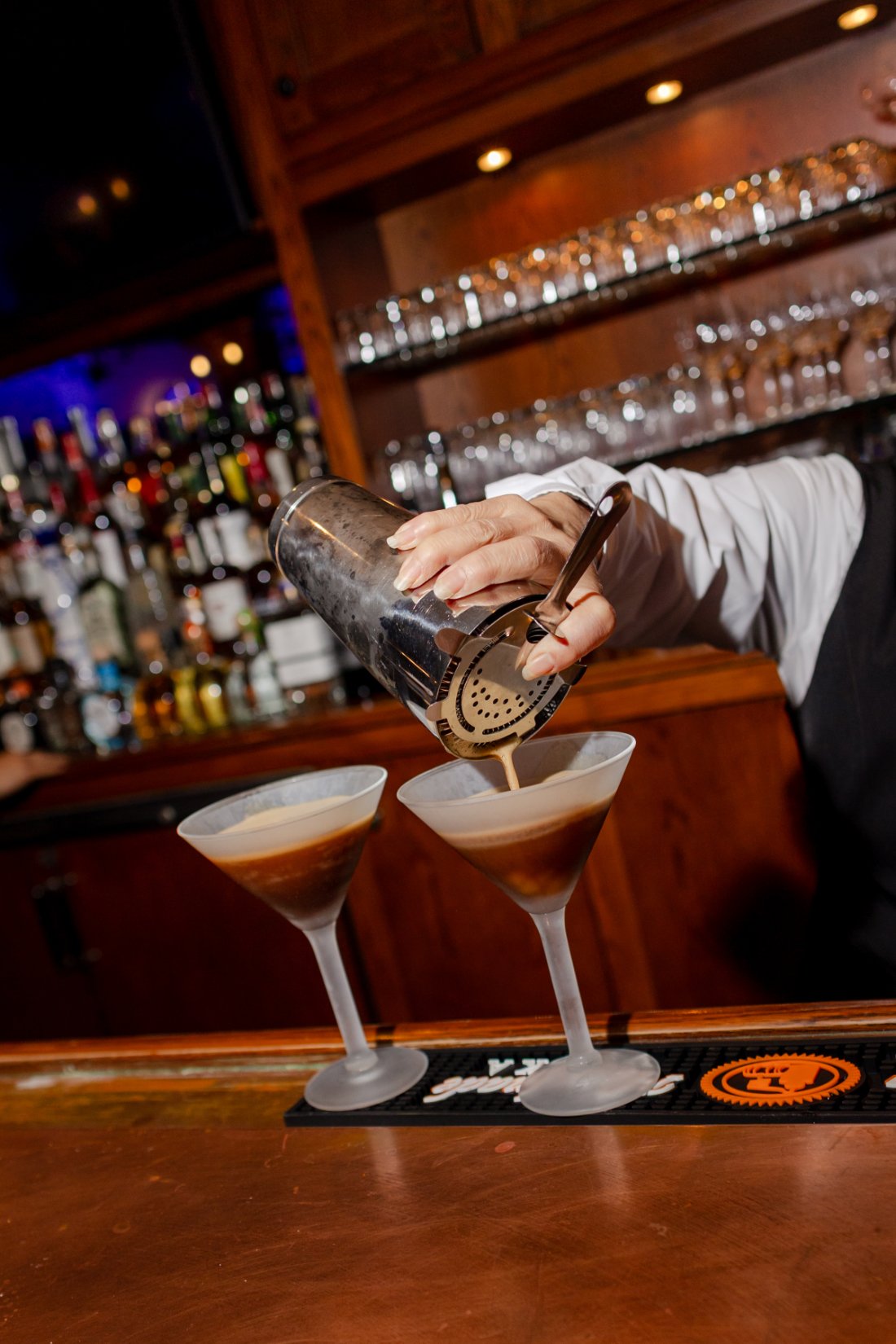 Espresso martinis being freshly poured at the wedding reception bar.