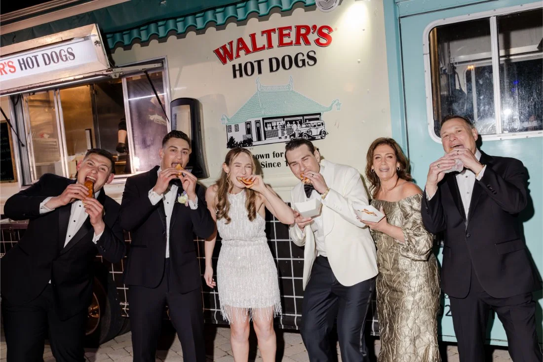Amanda and Ethan celebrating with family and friends at the Walter’s Hot Dogs truck during their Quaker Ridge Golf Club wedding.