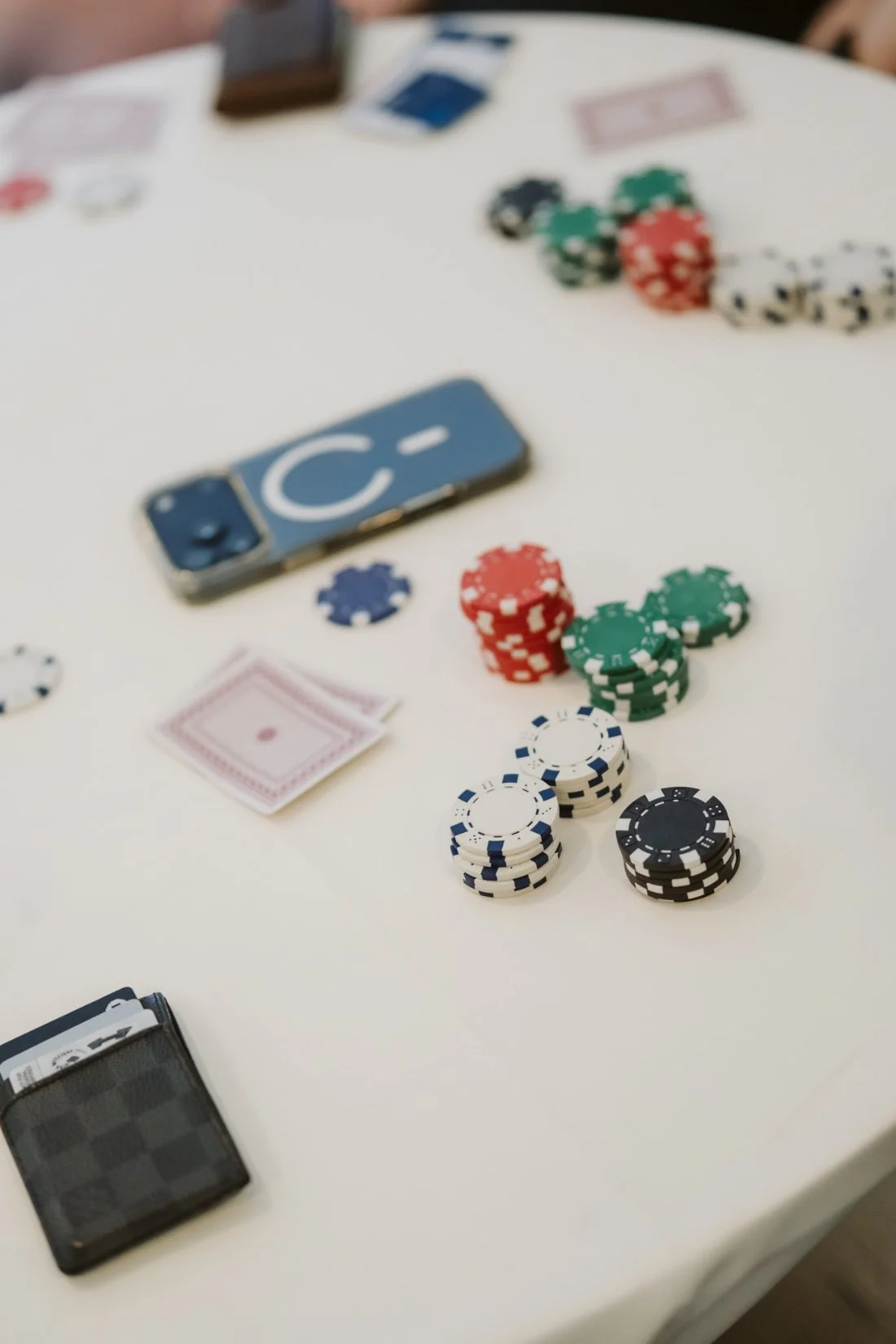Playing cards and colorful poker chips arranged on a table during the groom's wedding morning preparations.