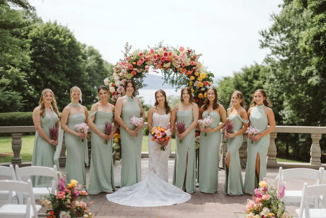 bridesmaids taking photos at the ceremony space 