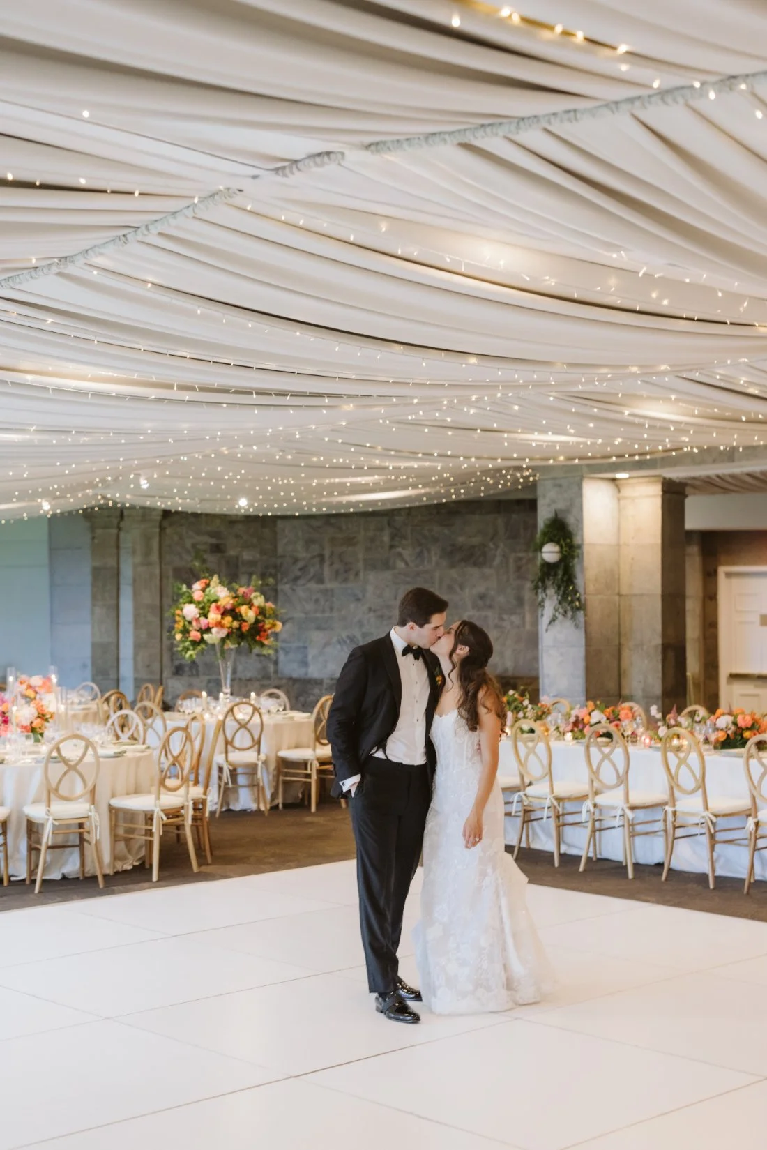 bride and groom admiring the planning and details of their reception space