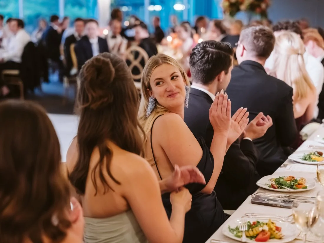 guests clapping after heartfelt speech.