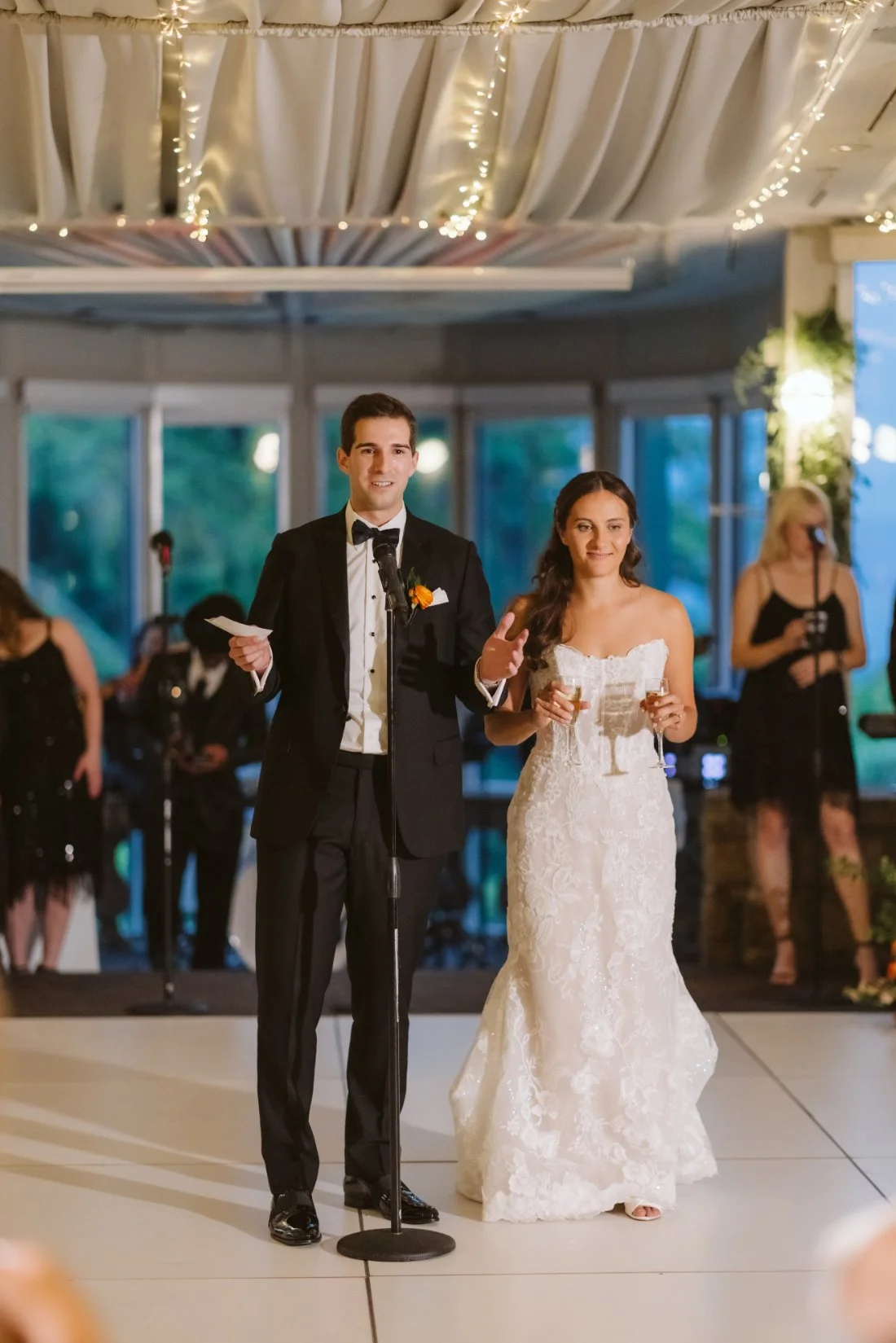Matt and Sydney giving a wedding reception speech together while holding champagne glasses at Tappan Hill Mansion.