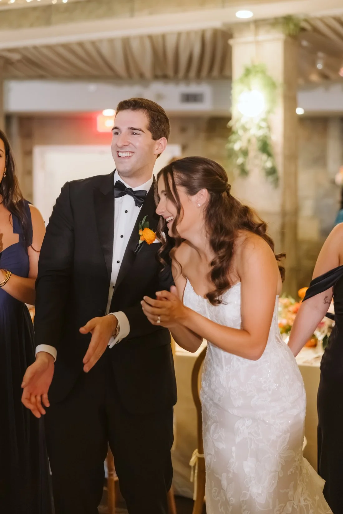 Sydney and Matt smiling and clapping during their wedding reception at Tappan Hill Mansion.