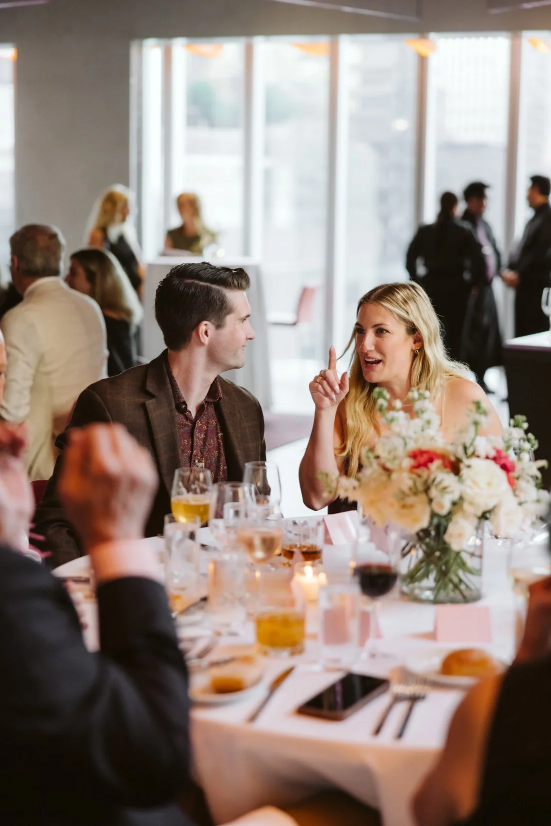 Bride and groom enjoy their rehearsal dinner surrounded by family and friends at Robert restaurant in NYC.