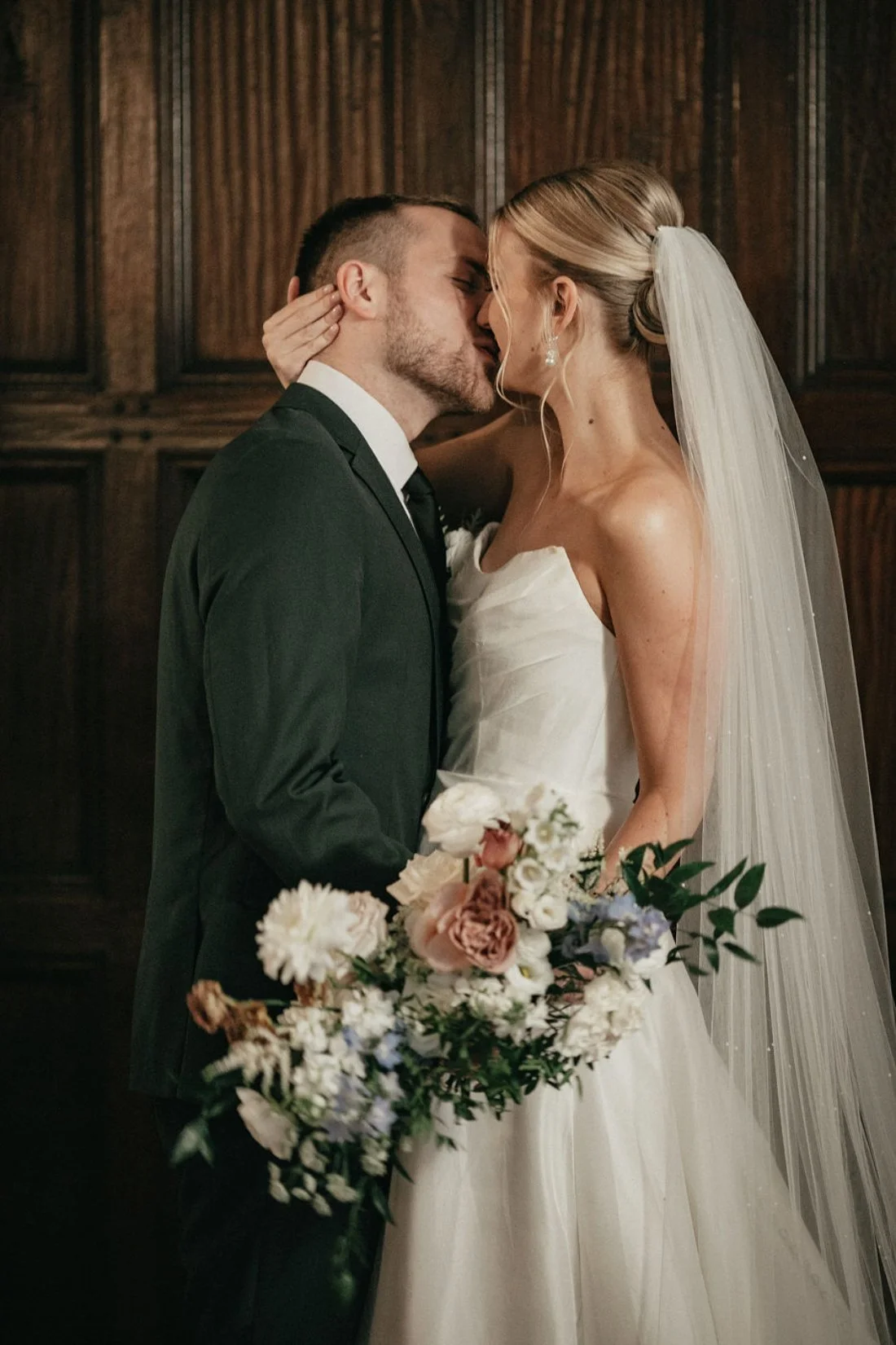 bride and groom kissing during their ski resort winter New York wedding