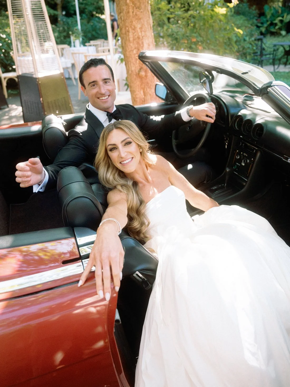 bride and groom in vintage car on their Hamptons wedding day in New York