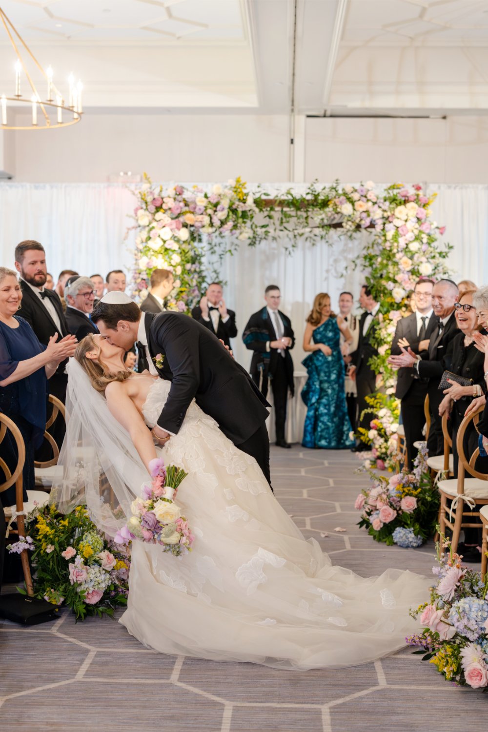 Lessons in business inspired by a beautifully designed indoor wedding ceremony featuring a floral arch and a joyful first kiss.