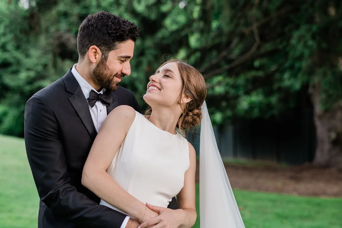 Newlyweds embracing outdoors during golden hour, showing how defining wedding priorities helps couples stay present and connected.