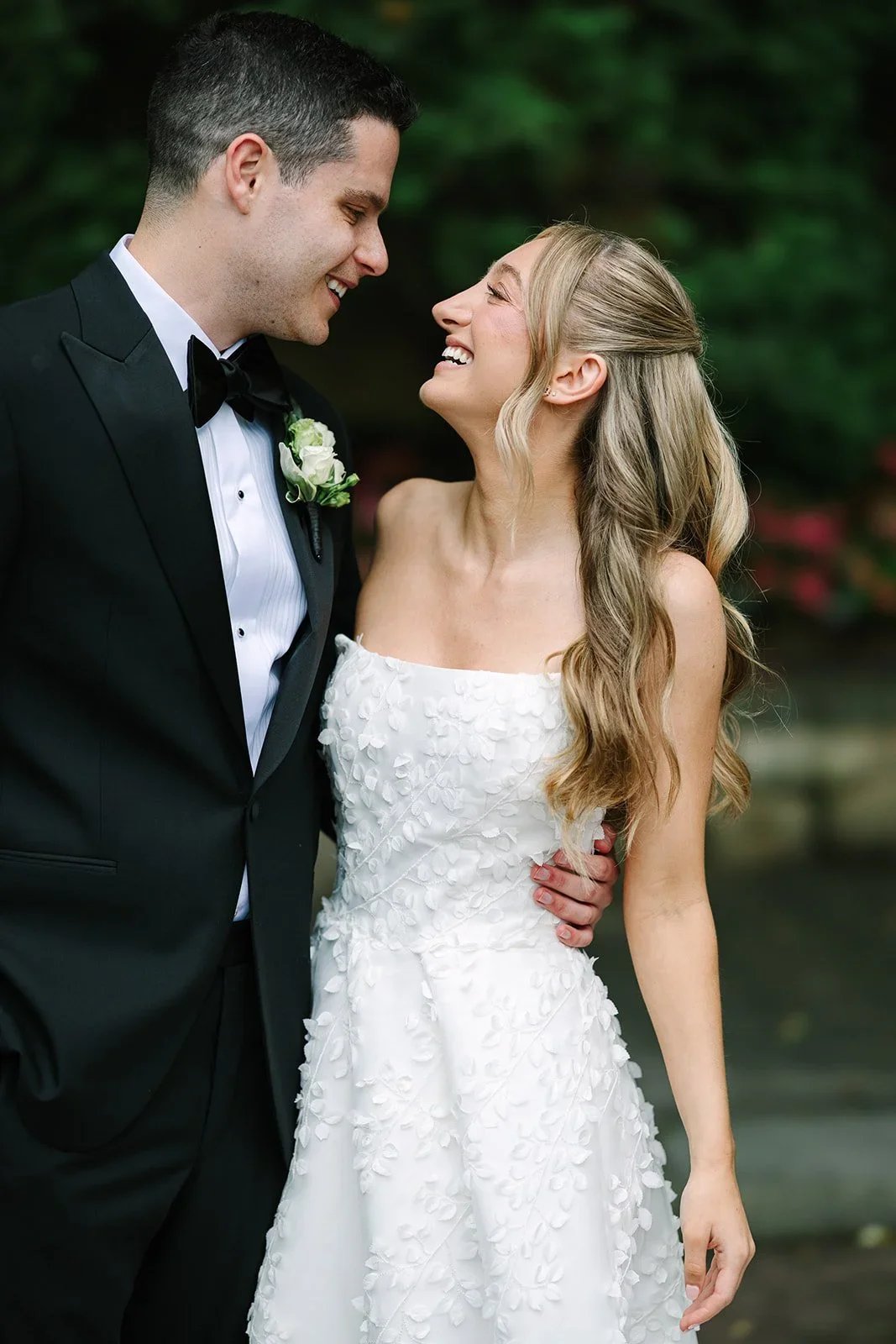 bride and groom lovingly smiling at each other after their first look