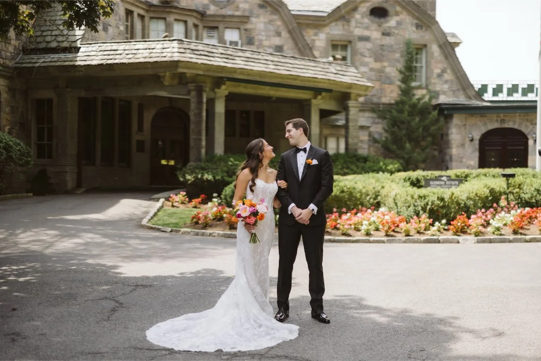 Bride and groom standing outside the Tappan Hill Mansion wedding venue in Tarrytown New York.