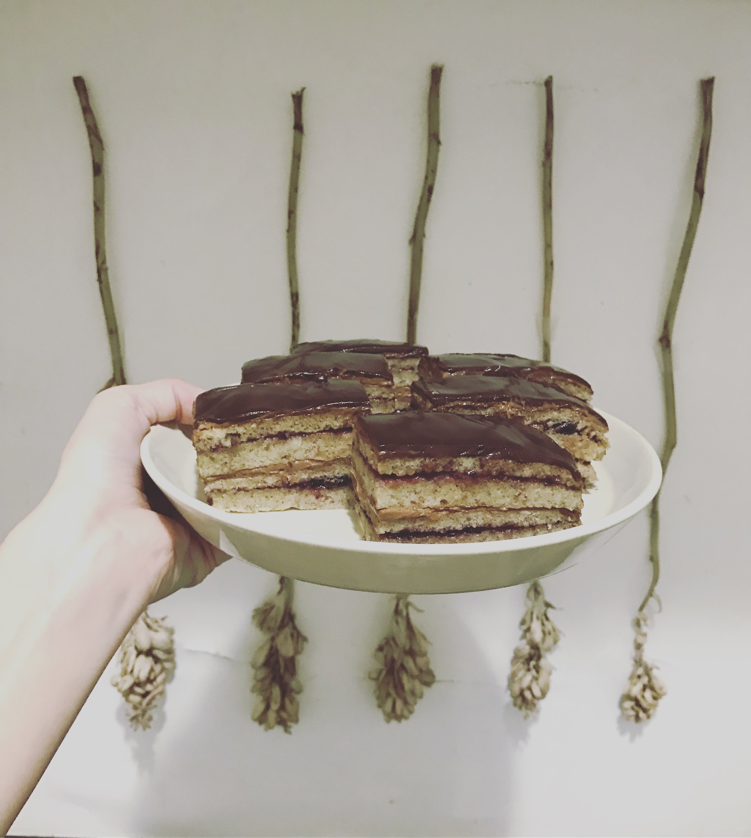 "opera cake" almond sponge, layered with chocolate buttercream and black currant jam, covered in chocolate ganache. my best yet