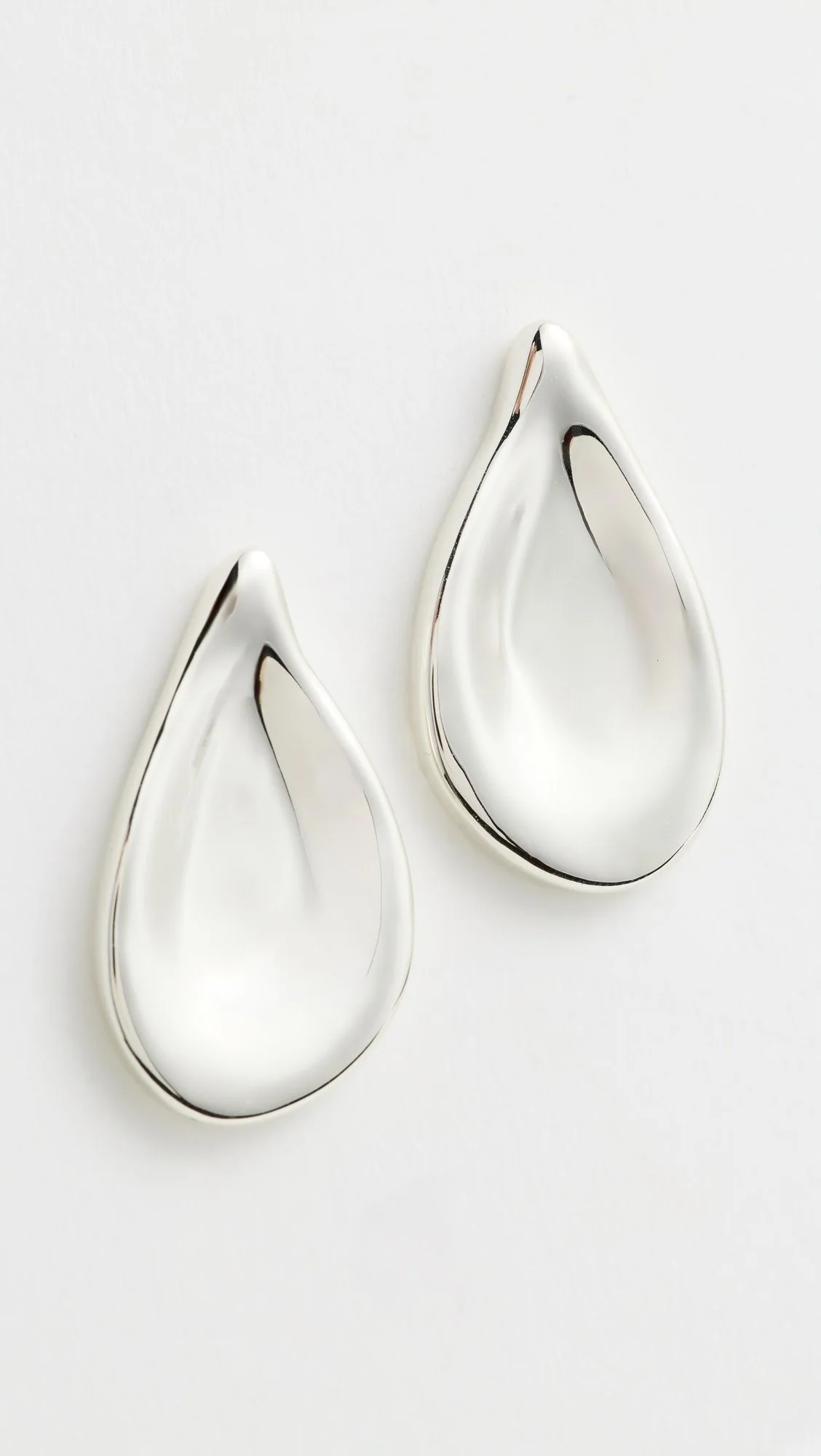 Silver teardrop-shaped earrings on a white background.