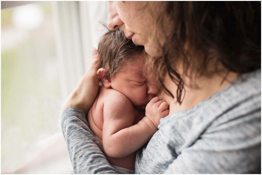 Lifestyle Newborn Photographer rochester NY Mama snuggling squishy newborn