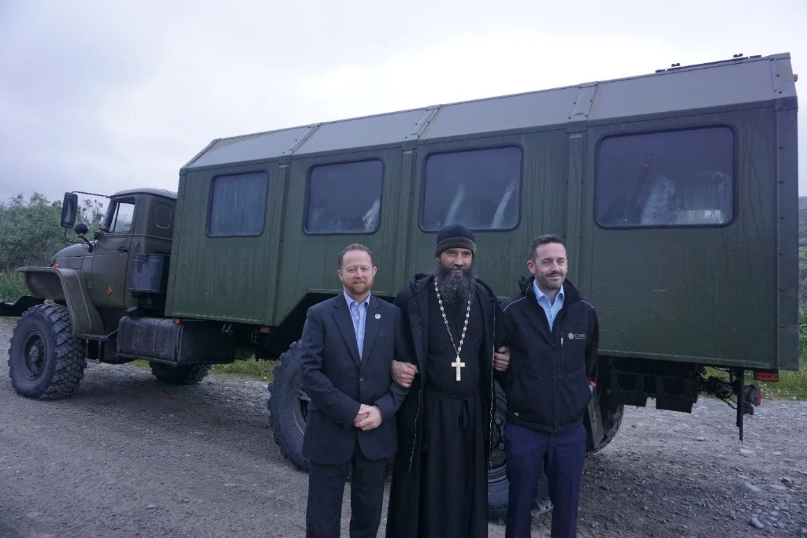 John Nicholls (left) and David McDonald (right) pictured alongside the Ural with Bishop Mitrophan (centre)