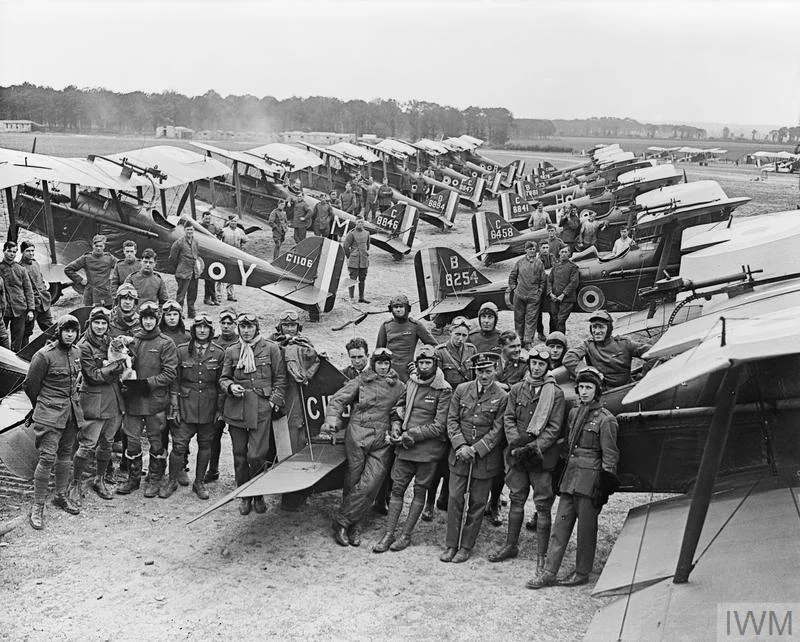 Officers and S.E.5a Scouts of No. 1 Squadron, RAF at Clairmarais aerodrome near Ypres. The group includes two Americans serving with the Royal Air Force, Lieutenants D. Knight (extreme left) and H. A. Kuhlberg (extreme right). © IWM (Q 12063)
