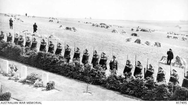 French soldiers salute the Memorial, surrounded by gardens and hay fields (AWM H17495)