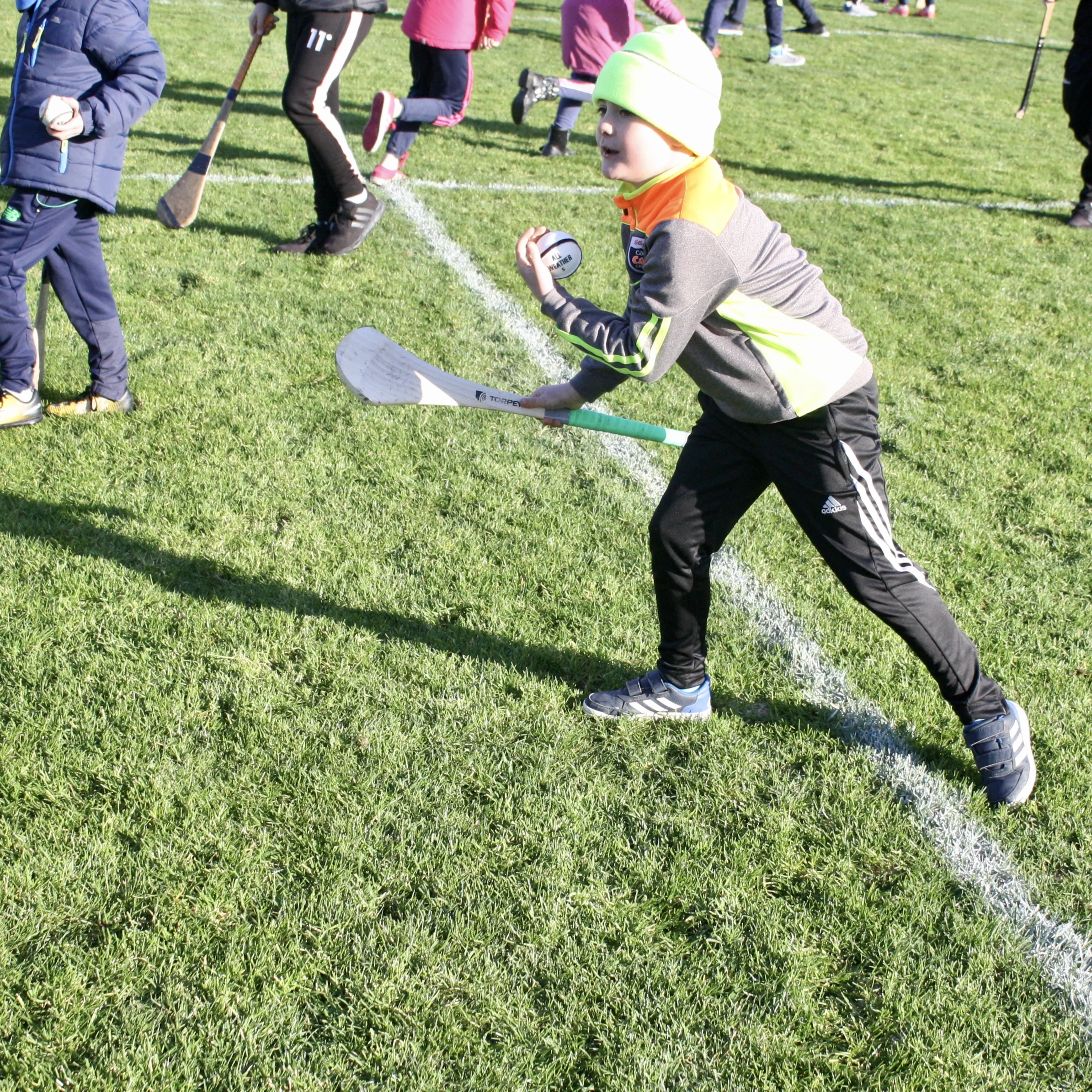 Fans having fun, and practicing their game, on the pitch during halftime. 
