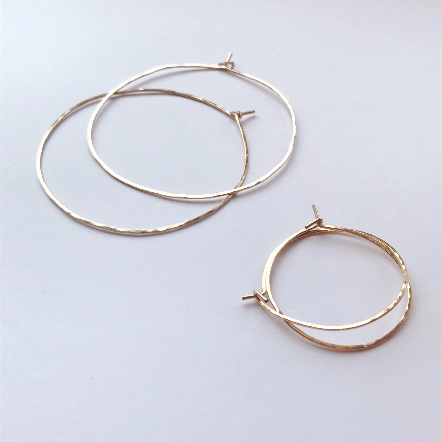 Classic gold hoops with a hammered textured finish created in 14k gold fill (Top) 2 inch diameter (bottom) 1 inch diameter