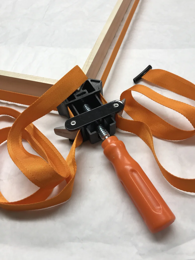 After applying wood glue to the mitered corners, and binding them together, I use a Pony Strap to ensure a tight bond.