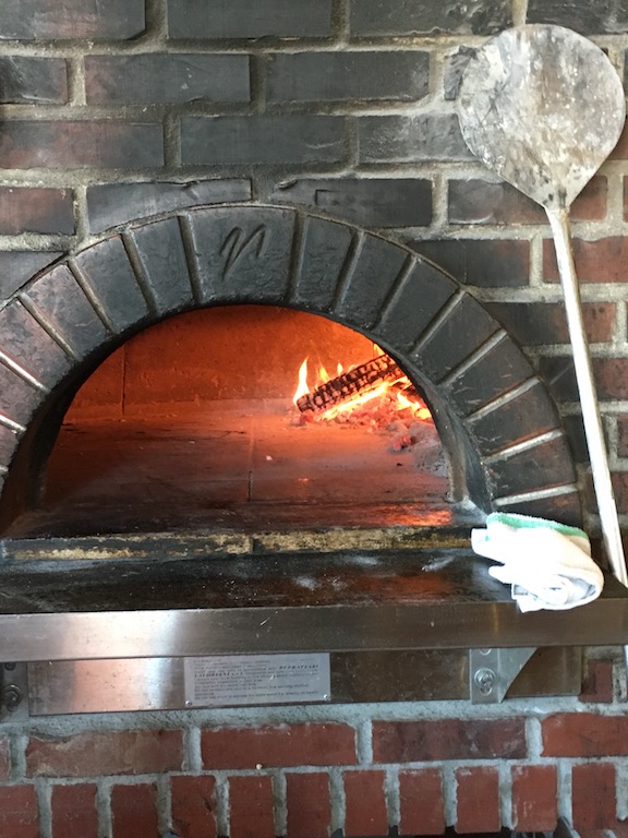Dante's famous wood-fired pizza oven. Nick says that humidity is the biggest factor in perfecting the restaurant's authentic Neapolitan crust -- so much so, that his team adjusts the recipe three times a year to account for Nebraska's weather changes.