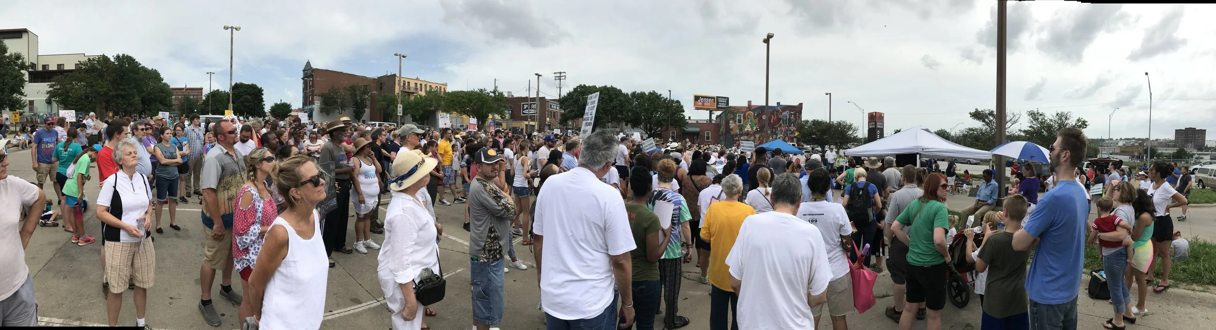 People gathering for Omaha's Families Belong Together rally.
