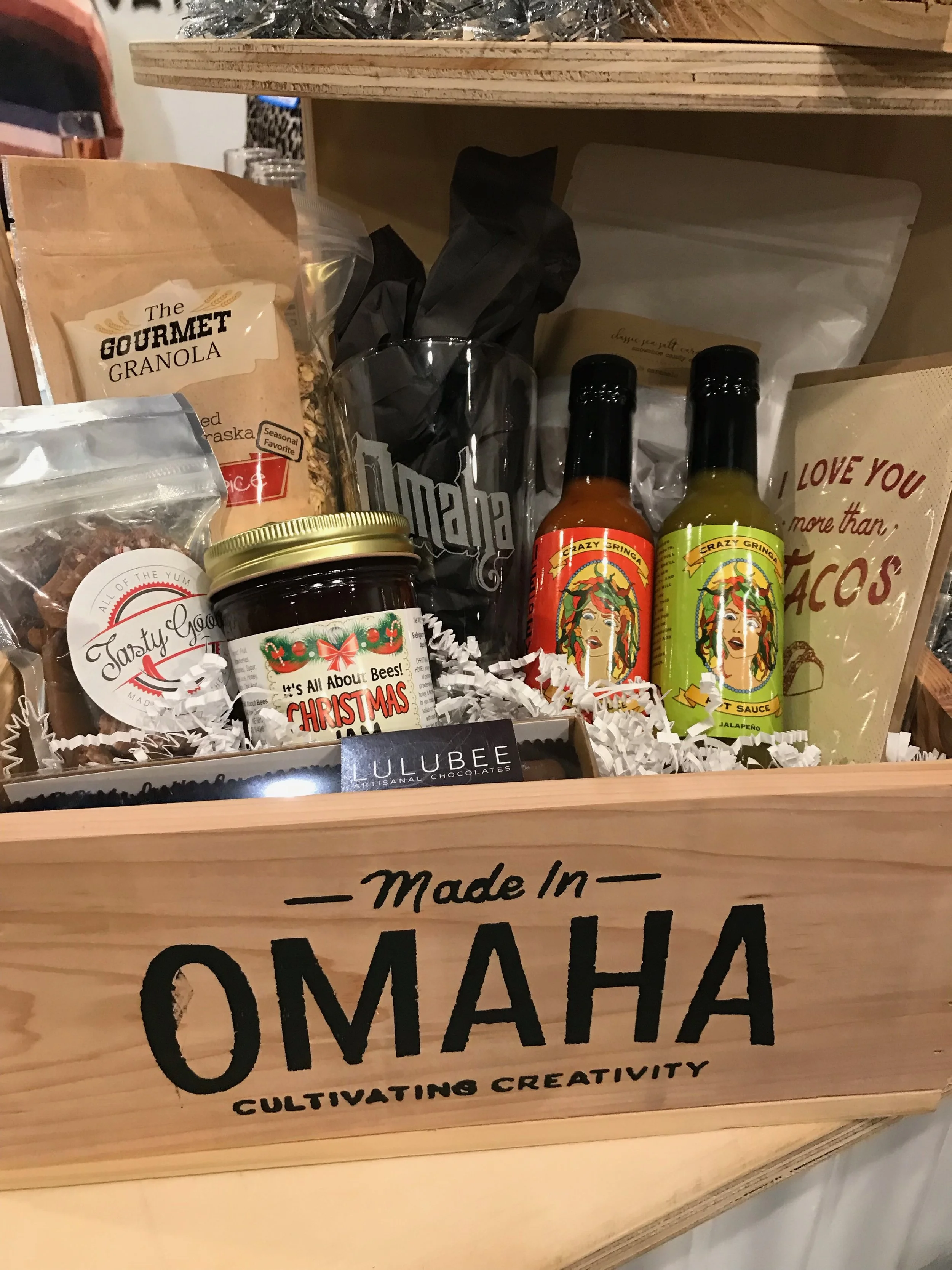 A Made in Omaha custom gift box for the gourmand includes locally made jam, granola, hot sauce, toffee, chocolates and other treats.
