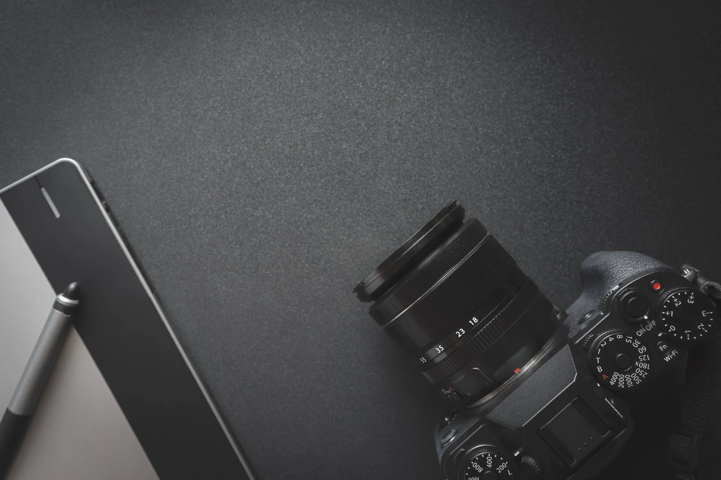 Top view of work space on dark table of a creative designer or p