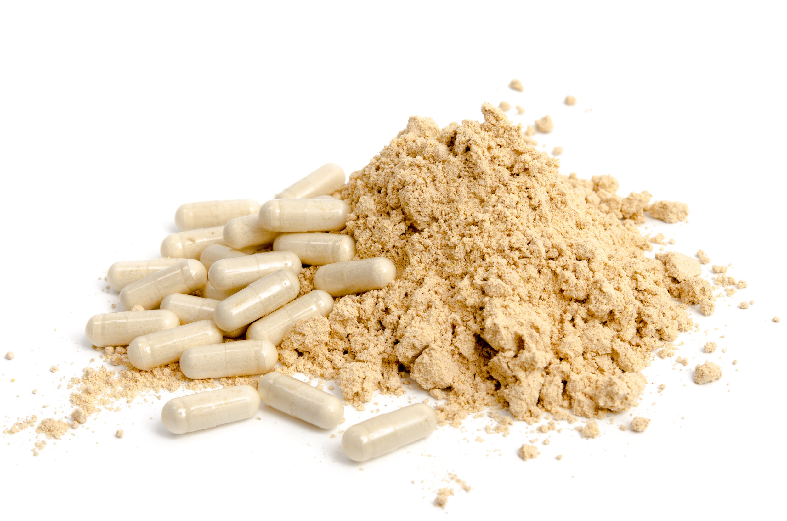 Pile of tan powder and powder in nutraceutical capsules