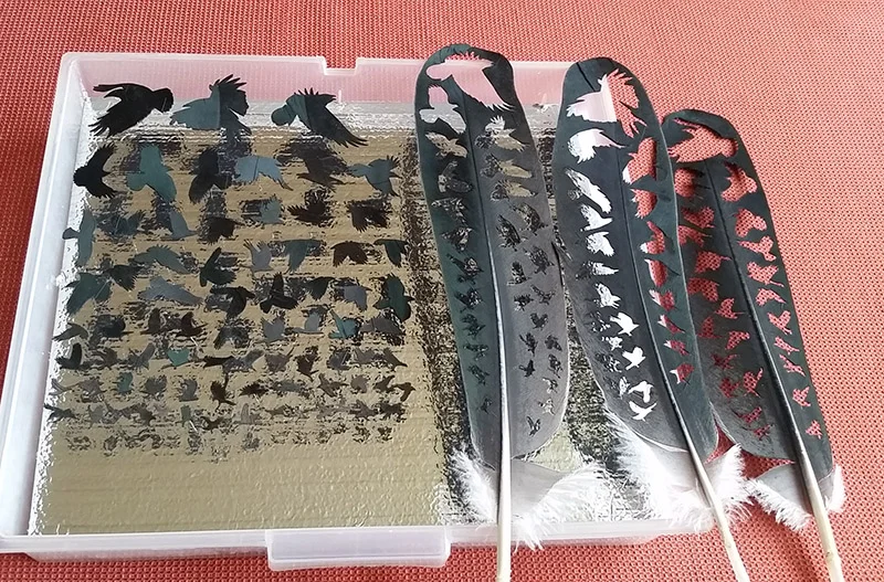 marabou stork feathers and cutouts ready for installation at the bainbridge Island Museum of Art
